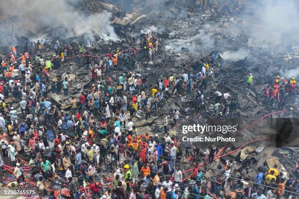 Firefighters and local people try to extinguish a fire that broke out in a clothing market in Dhaka, Bangladesh Bangladesh on April 04, 2023.