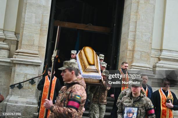 Ukrainian soldiers carry the coffin with the body of Roman Borovyk outside the church. Funerals of Maksym Deputat and Roman Borovyk, two Ukrainian...