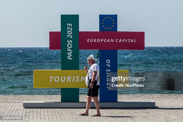 Tourist walks in front of an installation about Paphos smart tourism project, Paphos, Cyprus, on Apr. 4, 2023. Cyprus sees massive increase in...