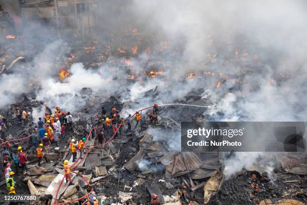 Firefighters try to extinguish a fire that broke out in a clothing market in Dhaka, Bangladesh early on Tuesday, April 04, 2023. 48 units of the Fire...