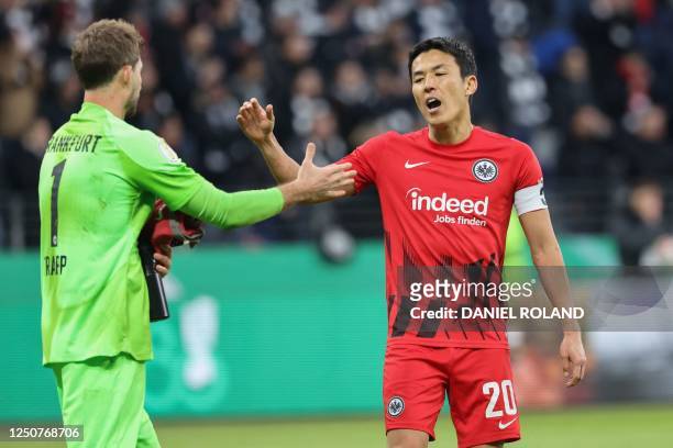 Frankfurt players including German goalkeeper Kevin Trapp and Frankfurt's Japanese midfielder Makoto Hasebe celebrate after winning the German Cup...