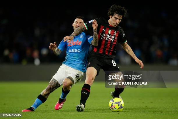 Napoli's Italian striker Matteo Politano challenges for the ball with AC Milan's Sandro Tonali during the Serie A football match between SSC Napoli...