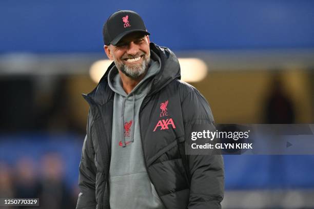 Liverpool's German manager Jurgen Klopp smiles as his players warm up ahead of the English Premier League football match between Chelsea and...