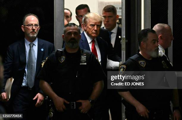 Former US President Donald Trump makes his way inside the Manhattan Criminal Courthouse in New York on April 4, 2023. - Donald Trump will make an...