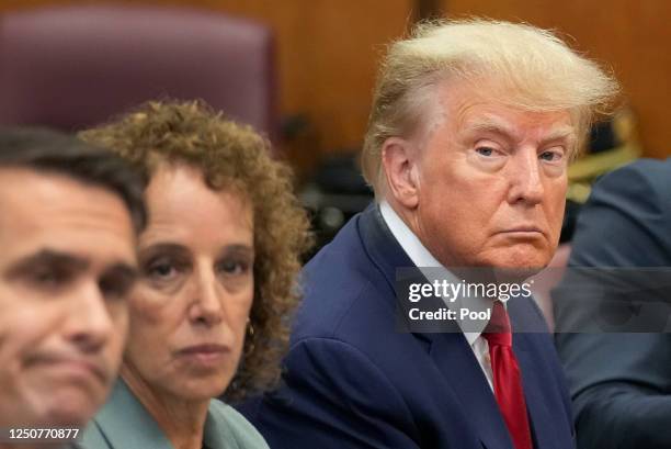 Former U.S. President Donald Trump sits at the defense table with his defense team in a Manhattan court during his arraignment on April 4 in New York...