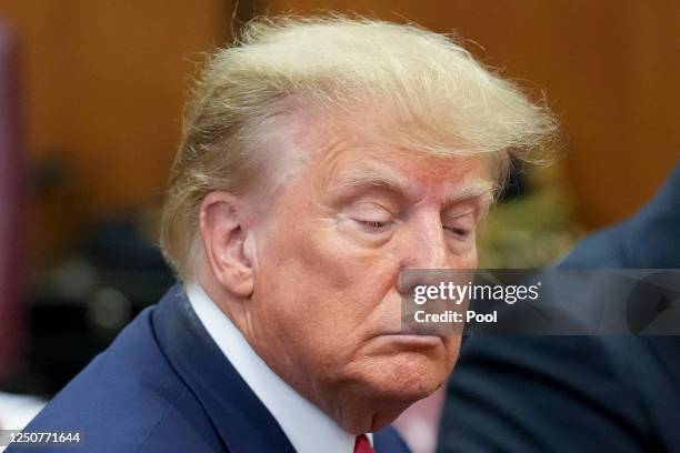 Flanked by attorneys, former U.S. President Donald Trump appears in the courtroom for his arraignment proceeding at Manhattan Criminal Court on April...