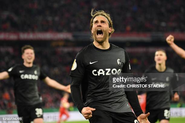 Freiburg's German forward Lucas Hoeler celebrates scoring the 1-2, the match winning goal from the penalty spot with his team-mates during the German...