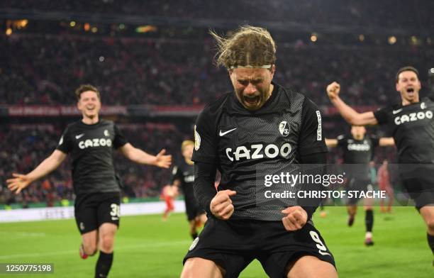 Freiburg's German forward Lucas Hoeler celebrates scoring the 1-2, the match winning goal from the penalty spot with his team-mates during the German...