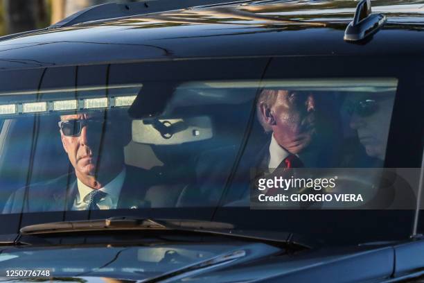 Former US President Donald Trump departs in a motorcade from Palm Beach International Airport in West Palm Beach, Florida on April 4, 2023. - Trump...