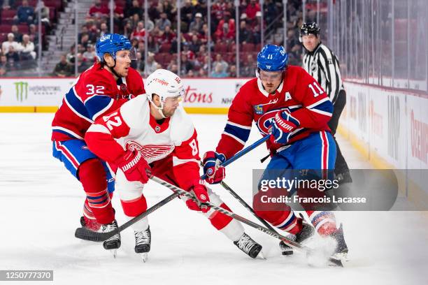 Jordan Oesterle of the Detroit Red Wings battles for the puck with Brendan Gallagher of the Montreal Canadiens during the first period of the NHL...