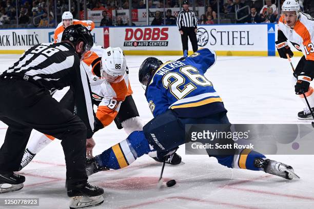 Nathan Walker of the St. Louis Blues wins a face-off against Joel Farabee of the Philadelphia Flyers at the Enterprise Center on April 4, 2023 in St....