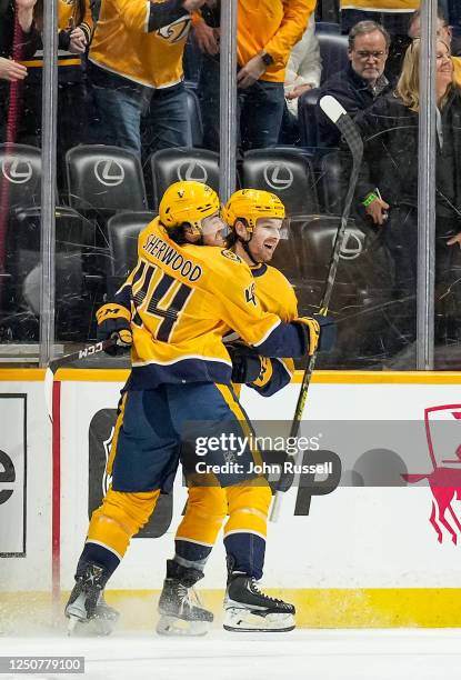 Tommy Novak celebrates his goal with Kiefer Sherwood of the Nashville Predators against the Vegas Golden Knights during an NHL game at Bridgestone...