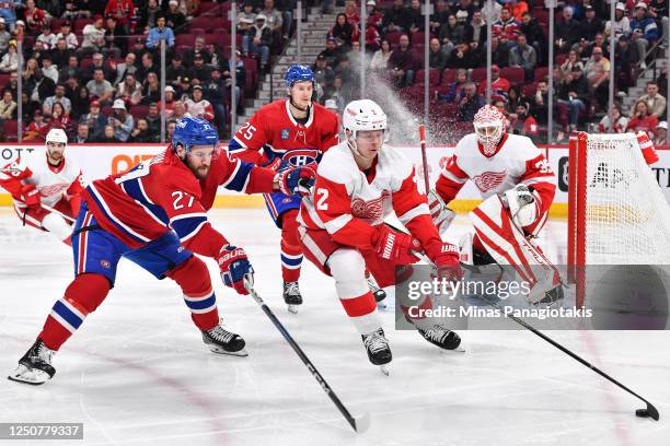 Olli Maatta of the Detroit Red Wings skates the puck against Jonathan Drouin of the Montreal Canadiens during the second period at Centre Bell on...