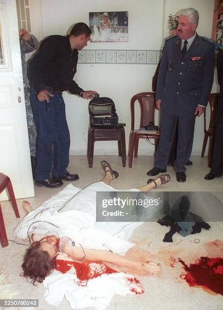 The body of American woman Bony Witheroll lays covered on the ground of the missionary clinic prior to being taken to the Hammud hospital in the...