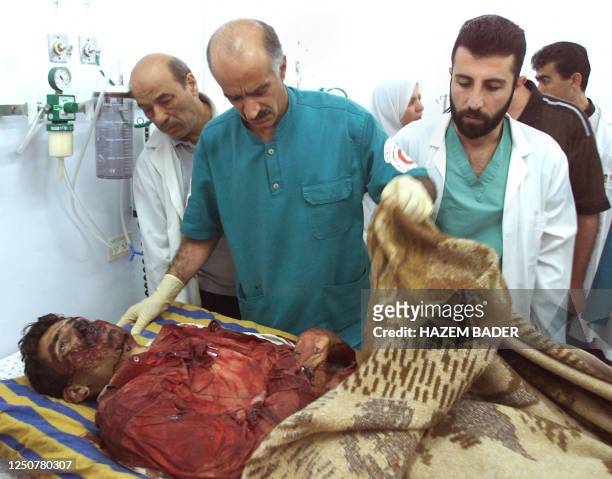 The bloodied body of Palestinian policeman Ashraf Deib, one of three policemen killed during an Israeli military operation on the local police...
