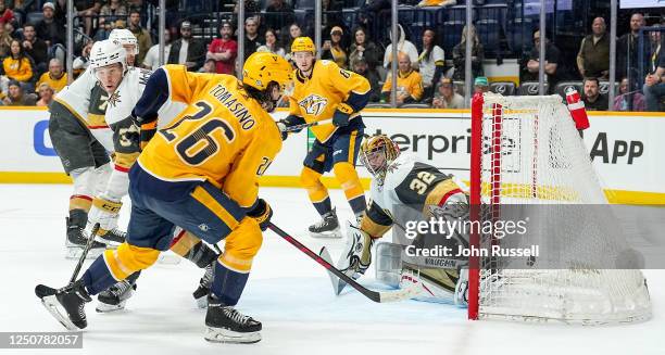 Cody Glass of the Nashville Predators scores the game winning overtime goal against Jonathan Quick of the Vegas Golden Knights as Philip Tomasino of...