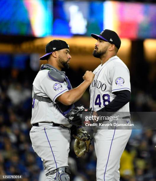 Starting pitcher German Marquez of the Colorado Rockies is comforted by catcher Elias Diaz before getting replaced during the sixth inning against...