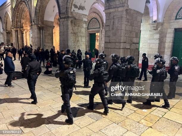 Israeli security forces walk in the Al-Aqsa Mosque compound in Jerusalem on April 5, 2023. - Clashes erupted inside the Al-Aqsa mosque in Jerusalem...