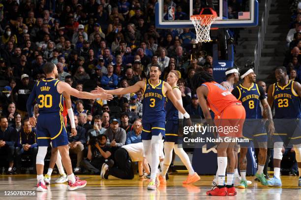 Stephen Curry of the Golden State Warriors high fives Jordan Poole during the game against the Oklahoma City Thunder on April 4, 2023 at Chase Center...
