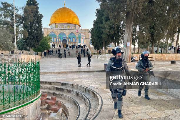 Israeli police walk inside the Al-Aqsa mosque compound in Jerusalem, early on April 5, 2023 after clashes erupted during Islam's holy month of...