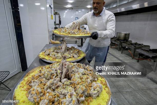 Ashraf al-Mubaideen co-owner of a traditional restaurant specialising in the traditional Jordanian dish "Mansaf" , prepares a meal at the kitchen in...