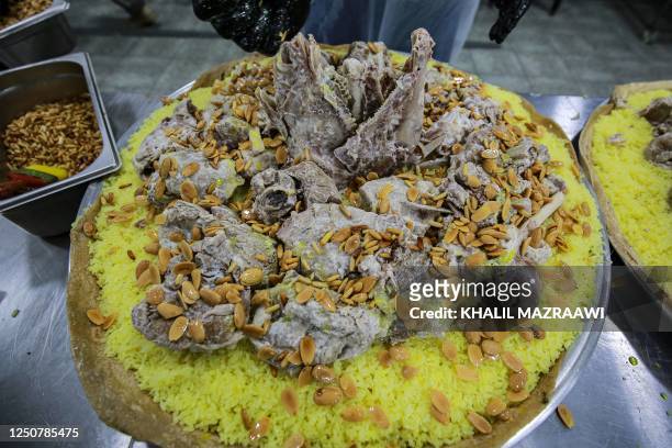 This picture taken on March 17, 2023 shows the Jordanian national dish "Mansaf" at a restaurant kitchen in Amman. - The kingdom's national dish was...