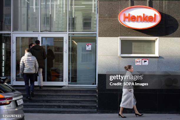 People walk by the Henkel office in Moscow. Recently, Russian media reported that the company has found a Russian buyer for its 11 Russia based...