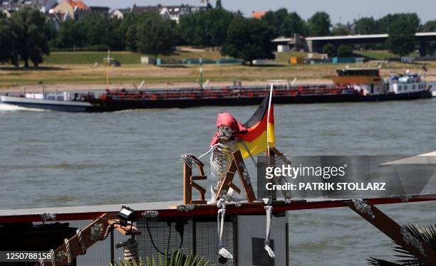 German flag hangs over a bar during the public viewing event of the FIFA Football World Cup 2010 match between England and Germany on the banks of...