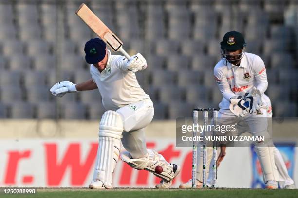 Ireland's Peter Moor plays a shot as Bangladesh's wicketkeeper Liton Das watches during the second day of the Test cricket match between Bangladesh...