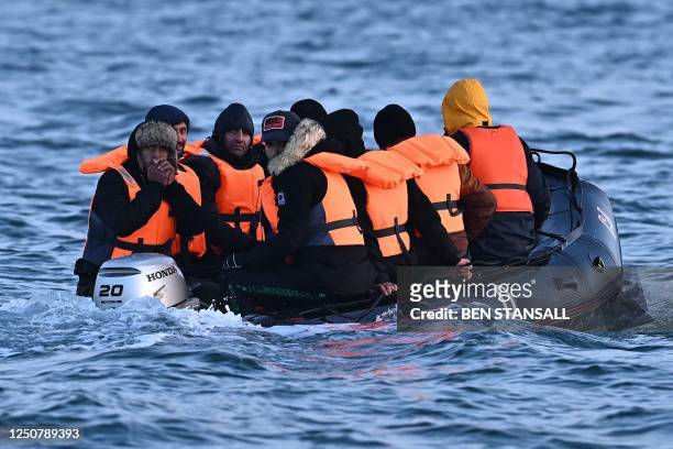 Migrants travel in an inflatable boat across the English Channel, bound for Dover on the south coast of England. More than 45,000 migrants arrived in...