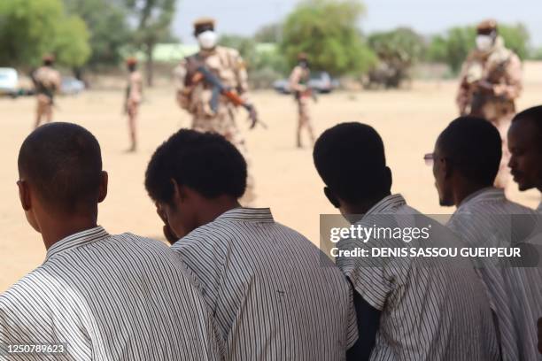 Pardoned rebels are seen guarded by Chadian soldiers following their release from the Klessoum prison in Ndjamena on April 5, 2023. - A group of 380...