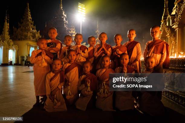 Young monks and nuns pose for a portrait while praying at Shwedagon Pagoda in Yangon. On February 1 the military junta government seized power by...