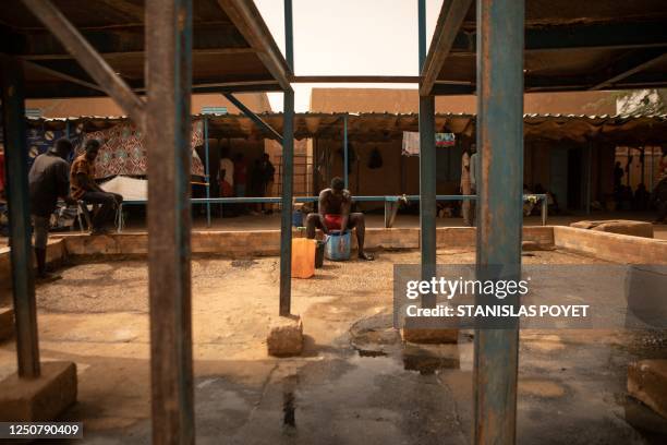 Migrant washes his laundry at the transit centre in Assamaka, Niger, on march 29 2023. - Every week, hundreds of migrants sent back from Algeria are...