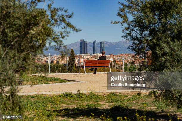 Visitor looks out towards the city skyline from a bench in the park area at the Bosque Metropolitano city forest site at Fuente Carrantona, in the...