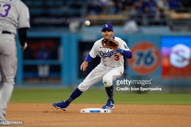 Los Angeles Dodgers shortstop Chris Taylor catches the ball to turn a double play during a regular season game between the Colorado Rockies and Los...