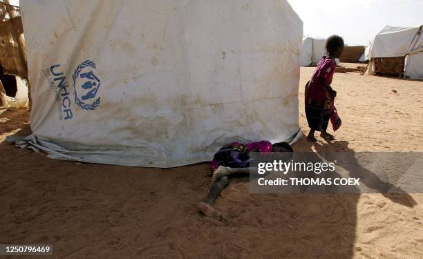 Sudanese refugee girls sleep in their camp in Iridimi with 15.000 other refugees, after they have fled the Darfur region where rebels attacked the...