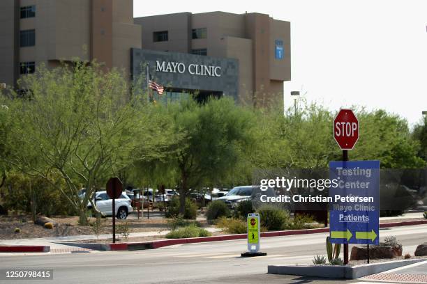 Signs direct arriving cars to a coronavirus screening area at a testing site erected in a parking lot at Mayo Clinic on June 19, 2020 in Phoenix,...