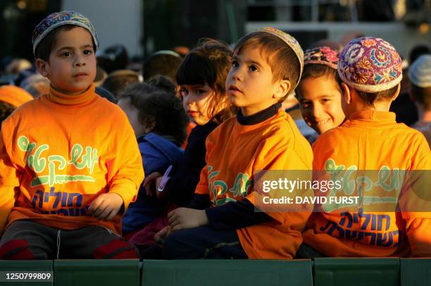 Children of Israeli settlers, wearing T-shirts in support of Gush Katif, are seen during a mass prayer organized in protest against Israeli Prime...