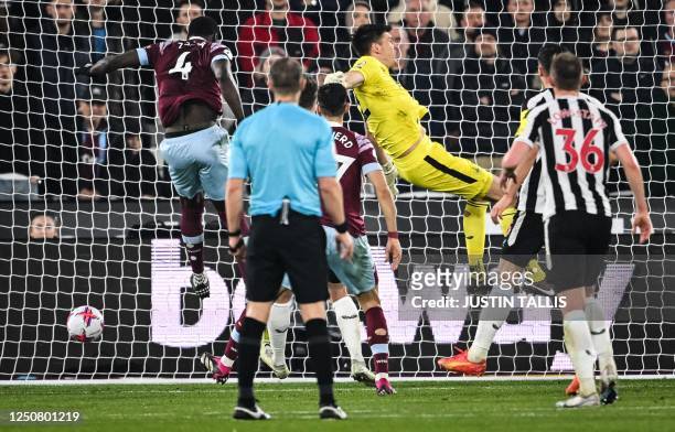 West Ham United's French defender Kurt Zouma heads the ball and scores his team first goal during the English Premier League football match between...