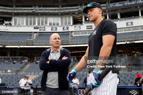 General Manager, Brian Cashman talks to Aaron Judge of the New York Yankees before the game against the Philadelphia Phillies at Yankee Stadium on...