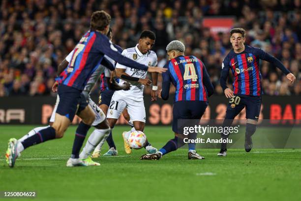 Real Madrid's forward Rodrygo vies with Barcelona's Uruguayan defender Ronald Araujo during the Kings Cup semifinal second leg one match between FC...