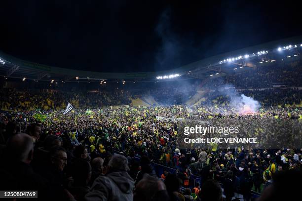 Supporters celebrate after winning the French Cup semi-final football match between FC Nantes and Lyon at the La Beaujoire Stadium in Nantes, western...