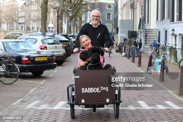 Peter Olsson and Claudelle Deckert and their dogs Bowie and Hilda in a cargo bike during a photo shoot on April 4, 2023 in Amsterdam, Netherlands.