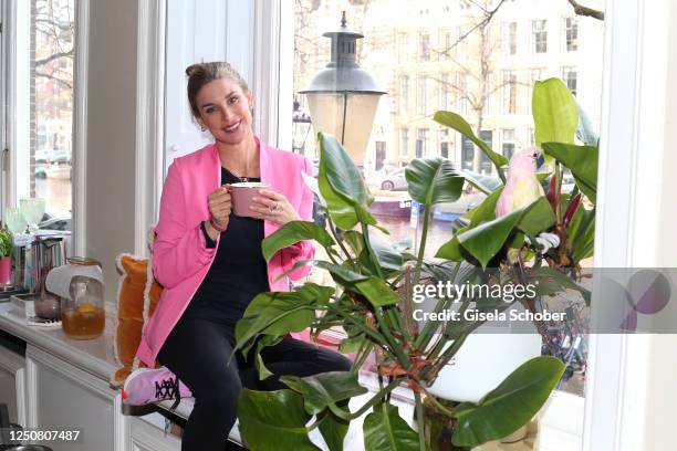 Claudelle Deckert poses at the window in the kitchen of her and Peter Olssons home during a photo shoot on April 4, 2023 in Amsterdam, Netherlands.