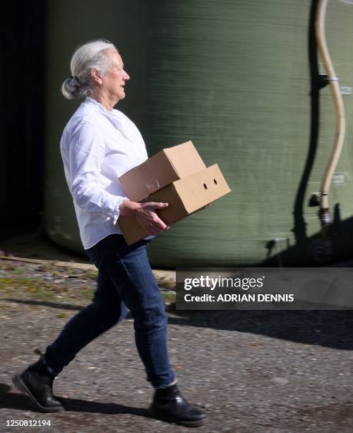 Stacey Hedges, Owner and Founder of Hampshire Cheese Company carries boxes of Tunworth cheese to an awaiting delivery van at the Hampshire Cheese...