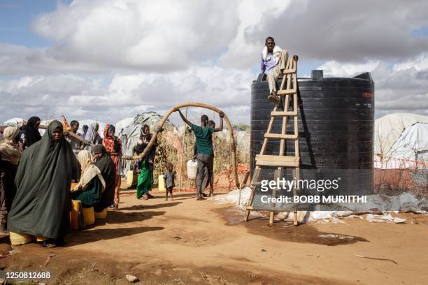 Somali refugees wait for the water distribution by French charity Doctors Without Borders in the Dadaab refugee camp, one of Africa's largest refugee...