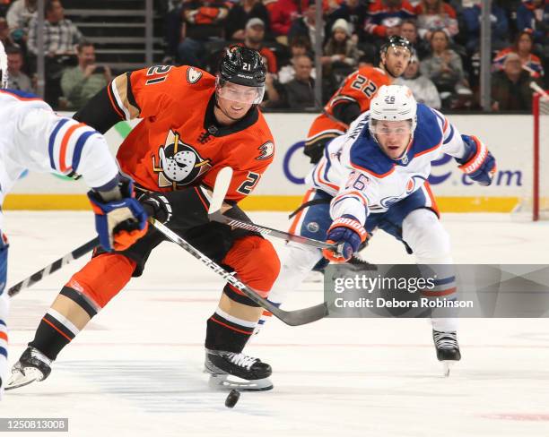 Isac Lundestrom of the Anaheim Ducks and Mattias Janmark of the Edmonton Oilers battle for position during the first period at Honda Center on April...