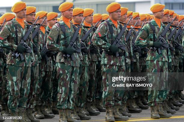 Air Force soldiers from the rapid attack command attend a rehearsal ceremony to mark the 77th anniversary of the Indonesian Air Force at a base in...