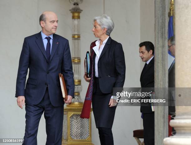 France's President Nicolas Sarkozy chats with France's Justice Minister Michel Mercier as France's Defence Minister Alain Juppe and France's Finance...