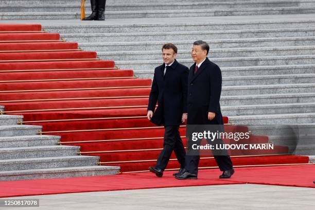 China's President Xi Jinping and his French counterpart Emmanuel Macron attend the official welcoming ceremony in Beijing on April 6, 2023.